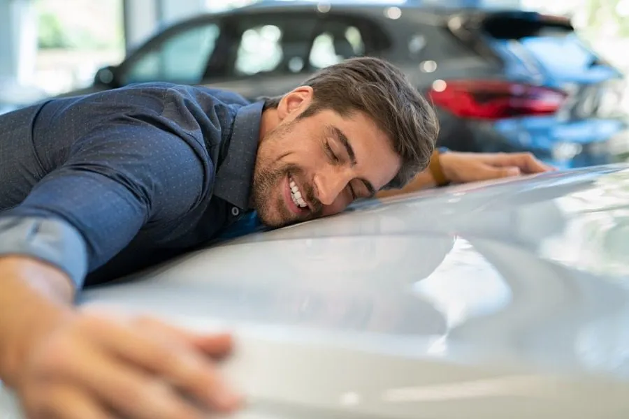 Man hugs car, happy to know how to track a car